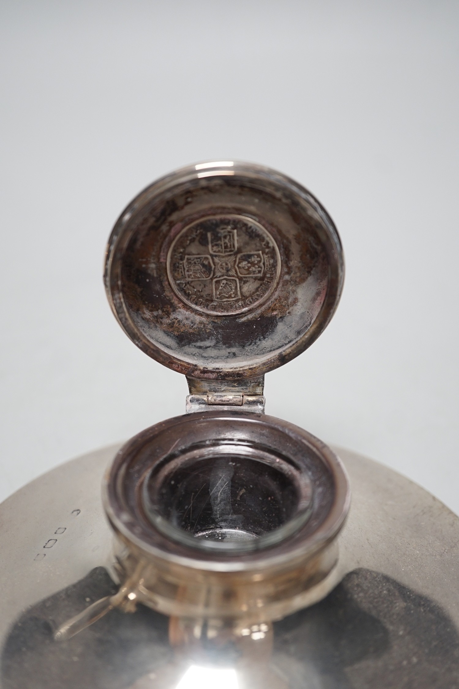 A George V silver mounted capstan inkwell, by Mappin & Webb, London, 1916, diameter 13.6cm and one other silver mounted capstan inkwell.